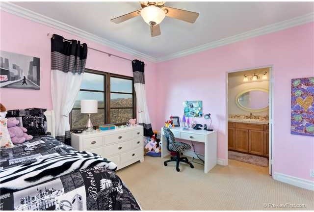 Inspiration for a medium sized mediterranean children’s room for boys in San Diego with pink walls and carpet.