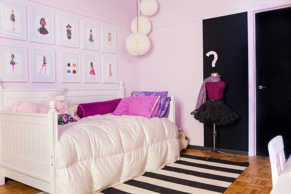This is an example of a traditional kids' bedroom for girls in Columbus with pink walls.