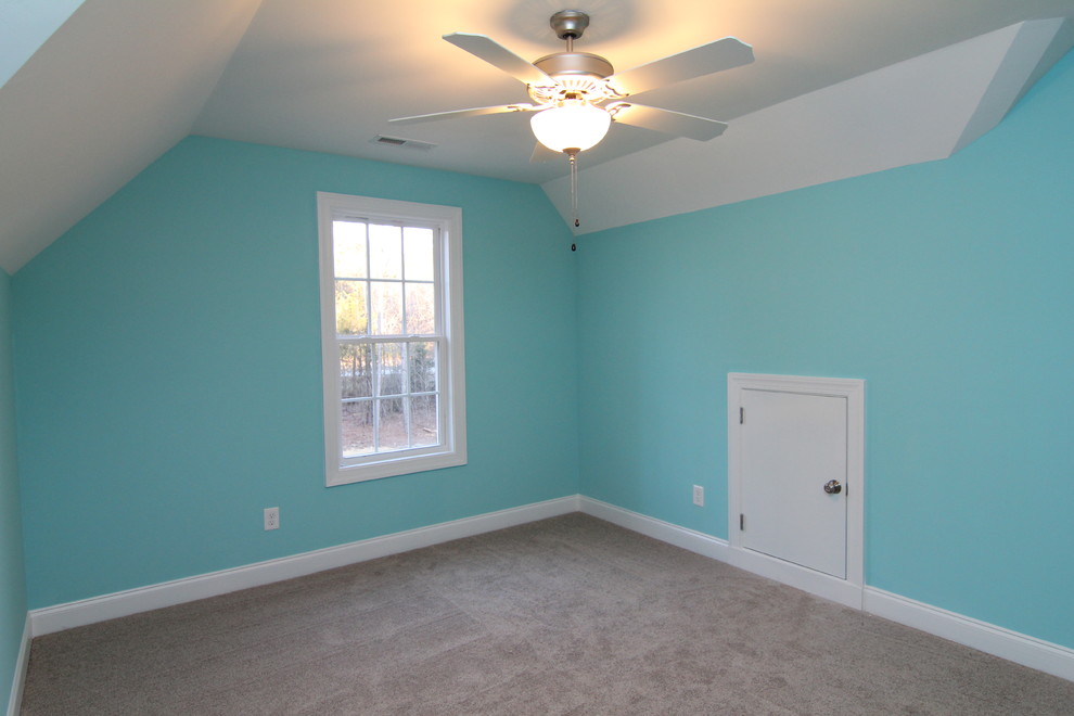 Medium sized contemporary gender neutral kids' bedroom in Raleigh with blue walls and carpet.