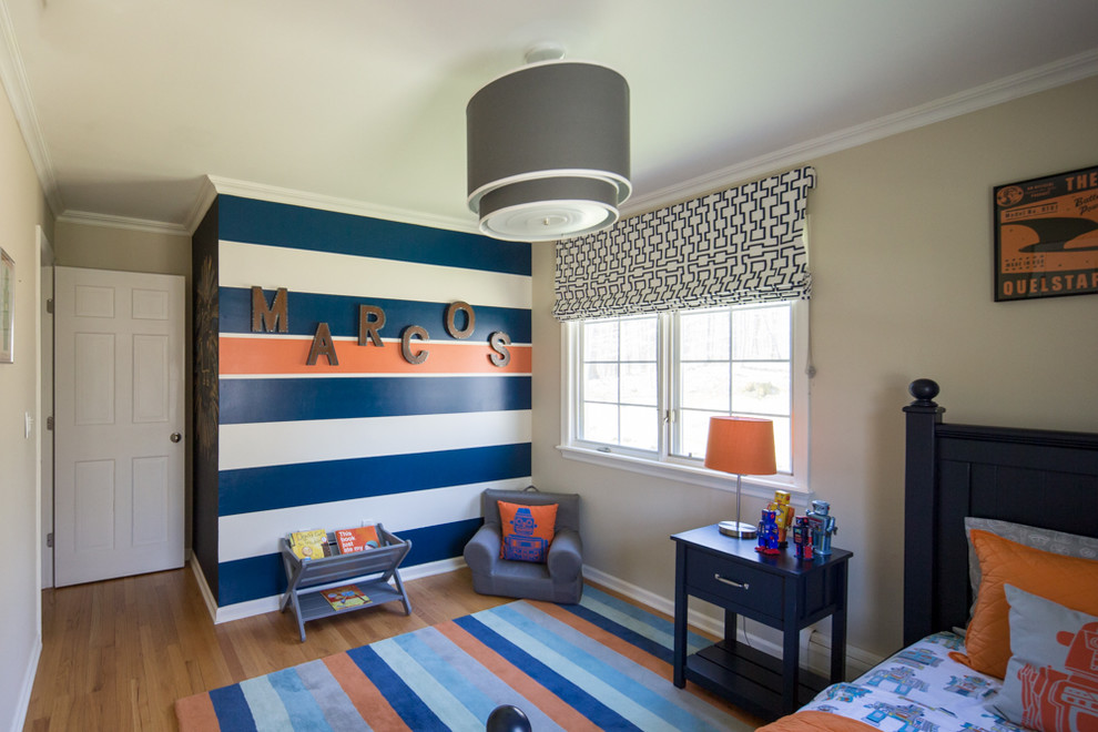 Design ideas for a medium sized classic children’s room for boys in New York with beige walls and light hardwood flooring.