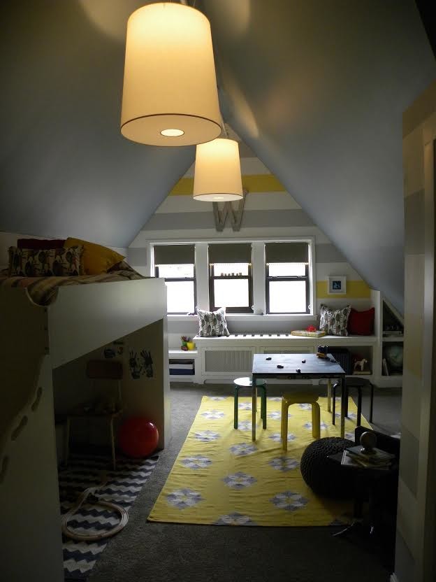 Medium sized bohemian toddler’s room for boys in Minneapolis with grey walls and carpet.