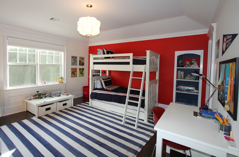 Large transitional boy dark wood floor and brown floor kids' room photo in New York with red walls