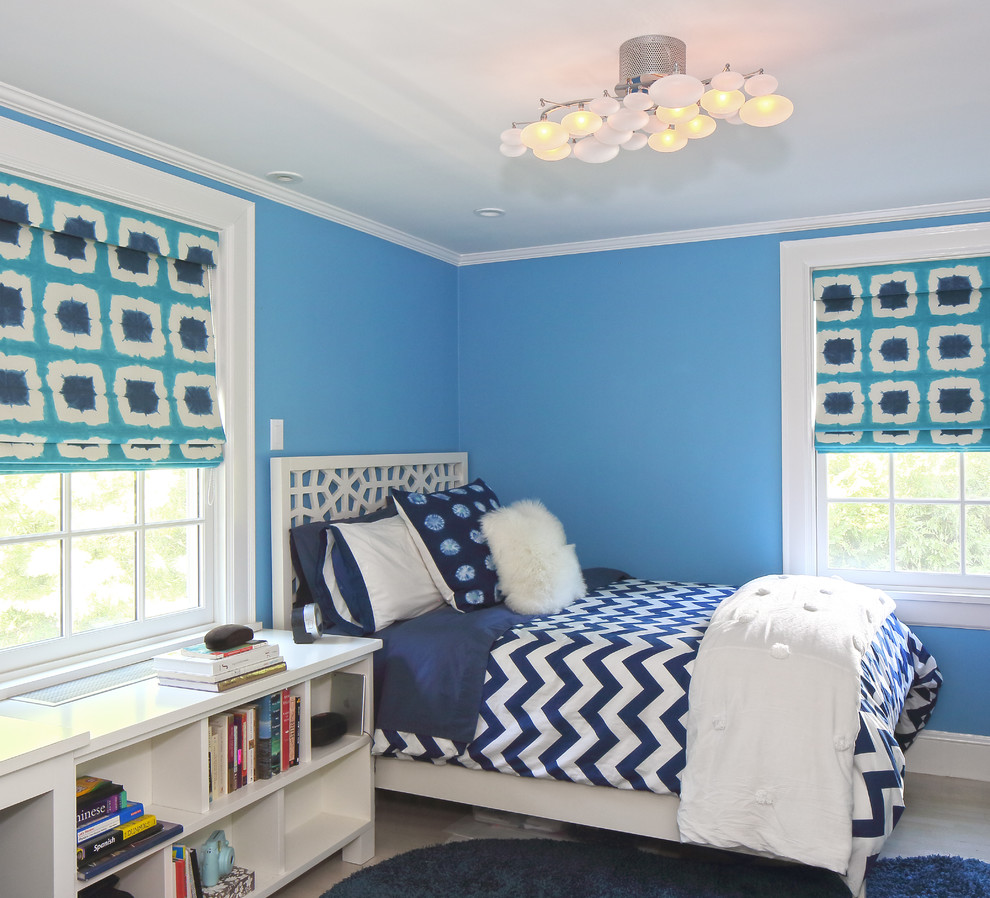 Kids' room - mid-sized transitional girl light wood floor kids' room idea in New York with blue walls