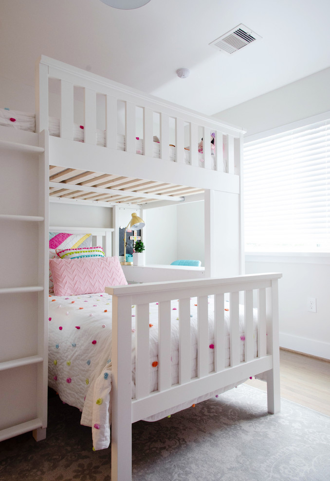 Example of a mid-sized minimalist girl kids' room design in Houston with white walls