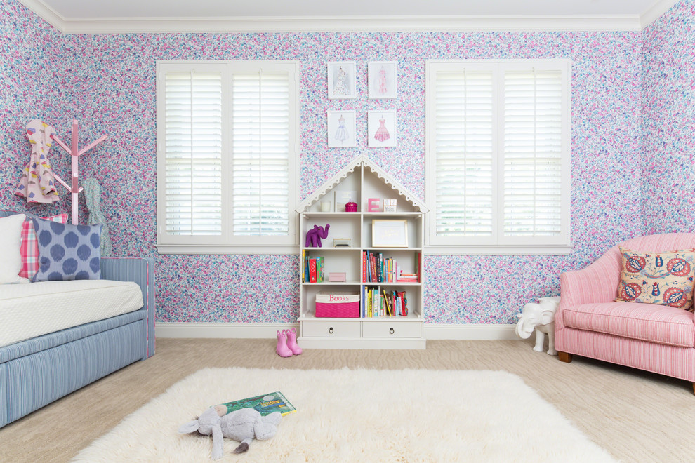 Example of a mid-sized classic girl carpeted kids' room design in Los Angeles with pink walls