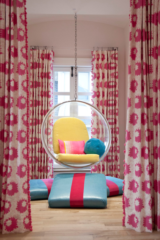 Trendy girl light wood floor kids' room photo in New York with pink walls