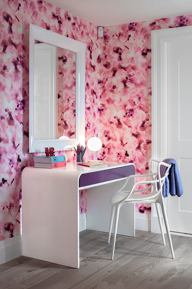 This is an example of a large contemporary kids' bedroom for girls in New York with pink walls, light hardwood flooring and brown floors.