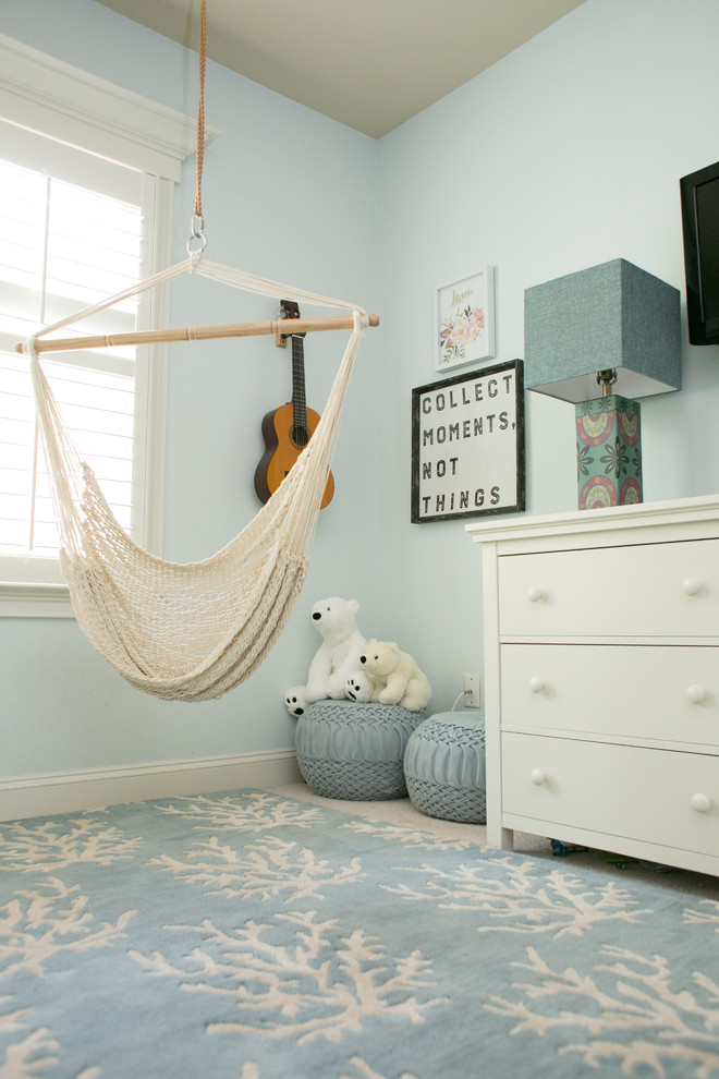 This is an example of a large nautical teen’s room for girls in Raleigh with blue walls, carpet and beige floors.