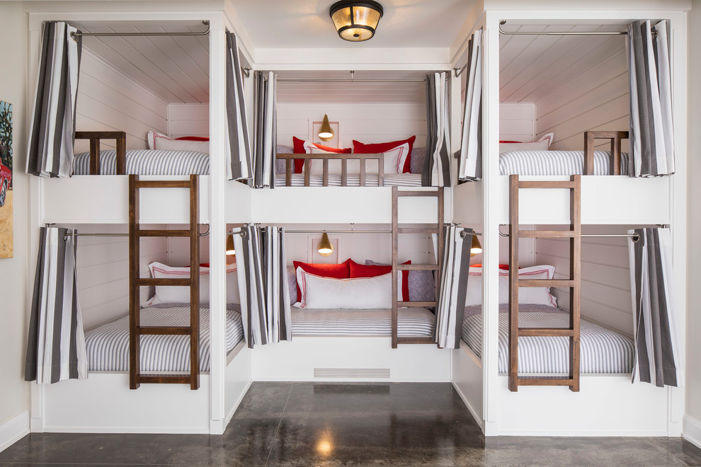 Example of a large beach style gender-neutral concrete floor and gray floor kids' room design in Minneapolis with white walls
