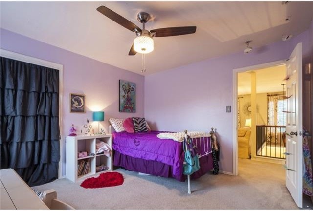 Small eclectic girl carpeted kids' room photo in Austin with purple walls