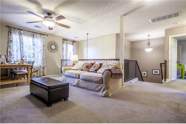 Mid-sized eclectic gender-neutral carpeted kids' room photo in Austin with beige walls