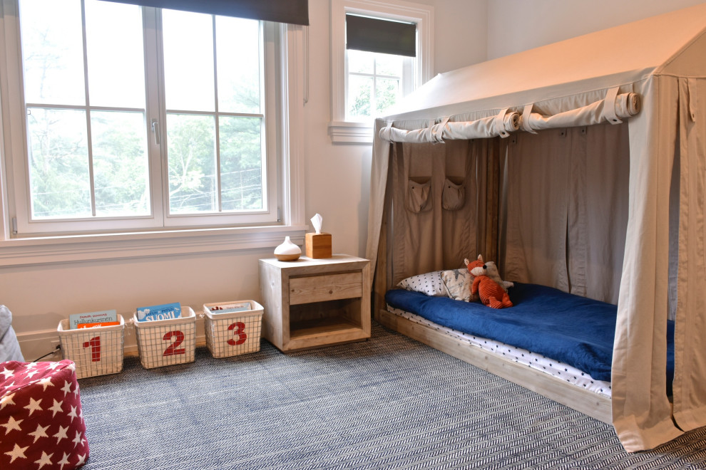 Inspiration for a traditional gender neutral children’s room in New York with white walls, carpet and grey floors.