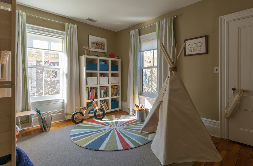 Immagine di una cameretta per bambini da 4 a 10 anni moderna di medie dimensioni con pavimento in legno massello medio e pareti beige