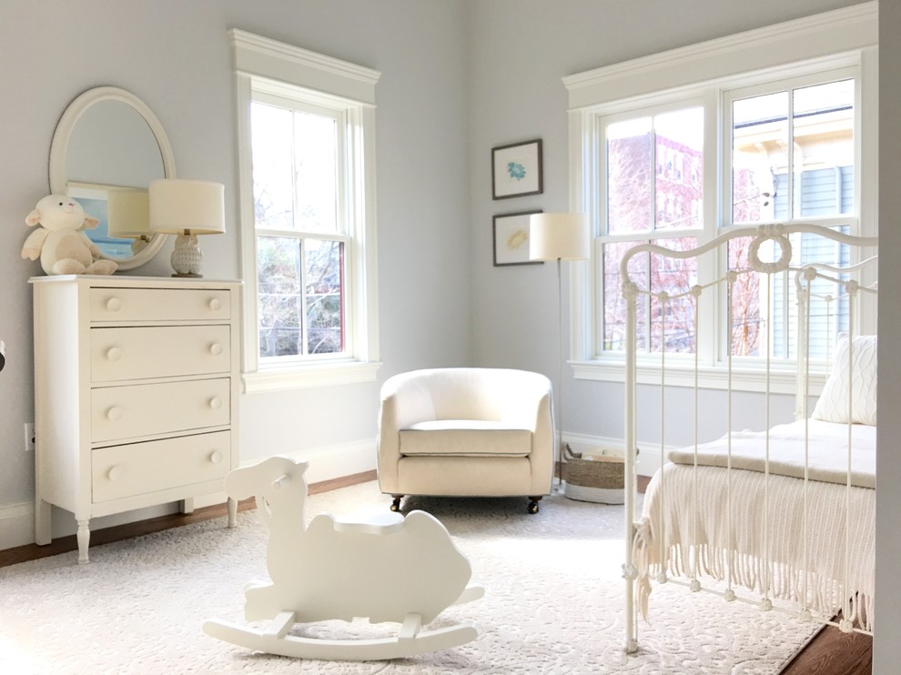 Photo of a classic gender neutral toddler’s room in Boston with grey walls and dark hardwood flooring.