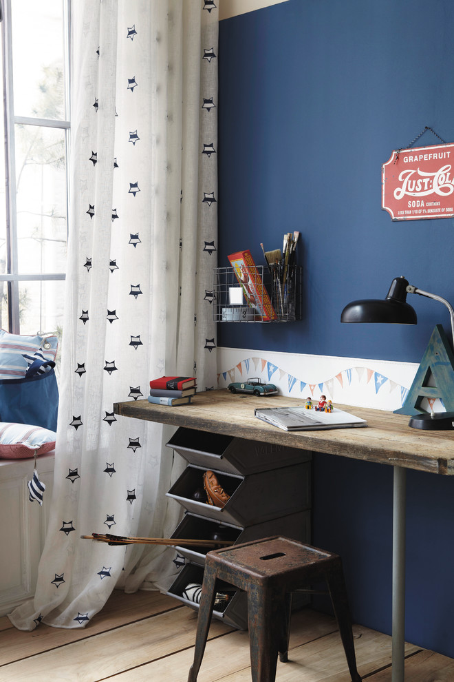 Design ideas for an industrial kids' study space for boys in Other with blue walls.