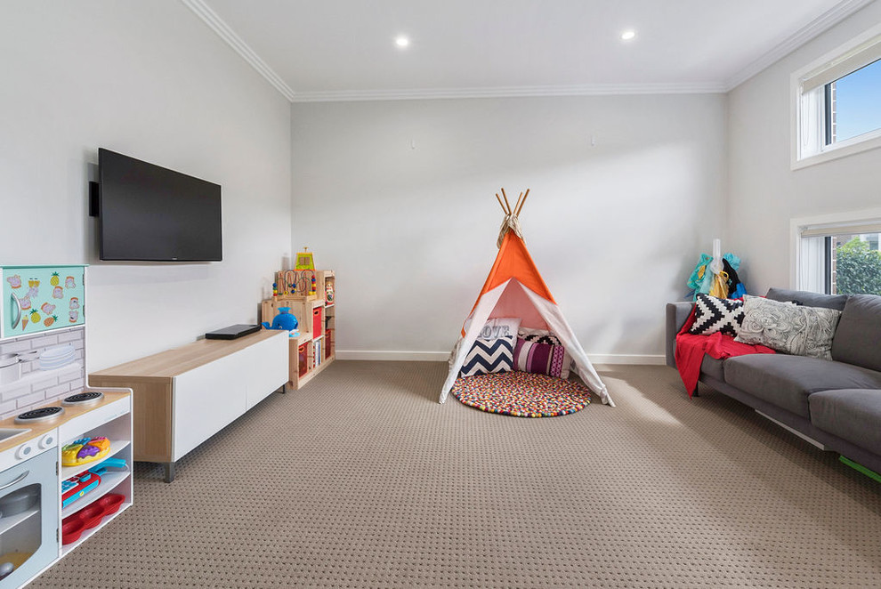 Trendy gender-neutral carpeted and beige floor playroom photo in Sydney with gray walls