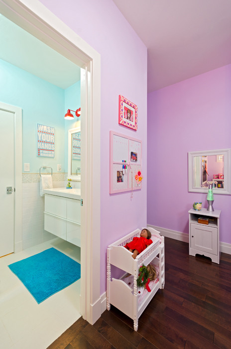 Medium sized traditional children’s room for girls in DC Metro with purple walls and dark hardwood flooring.