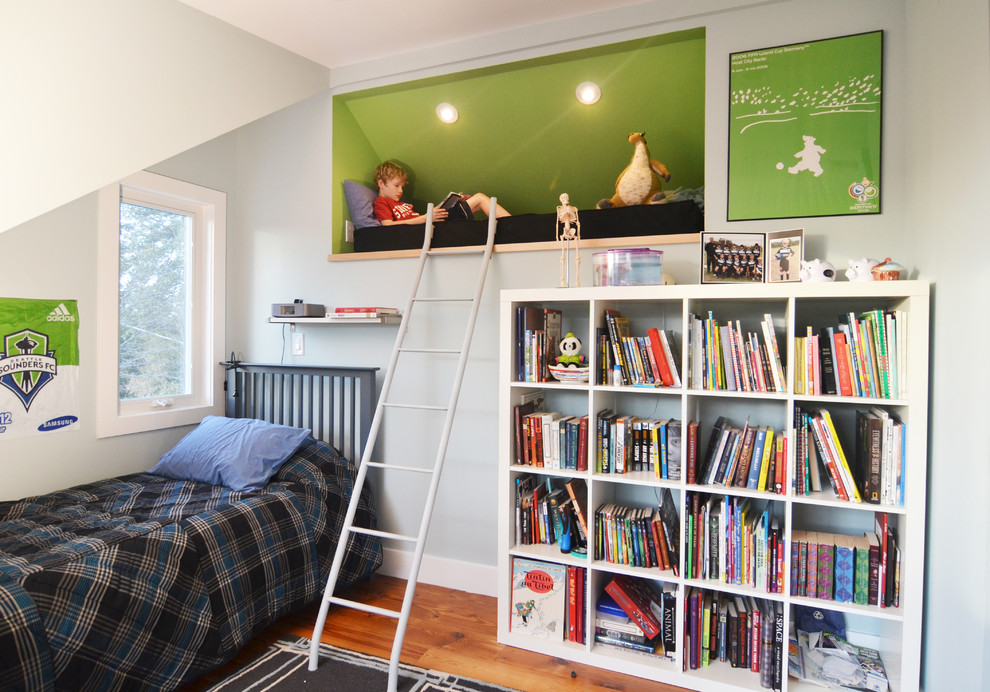 Example of a mid-sized trendy boy medium tone wood floor kids' room design in Austin with blue walls