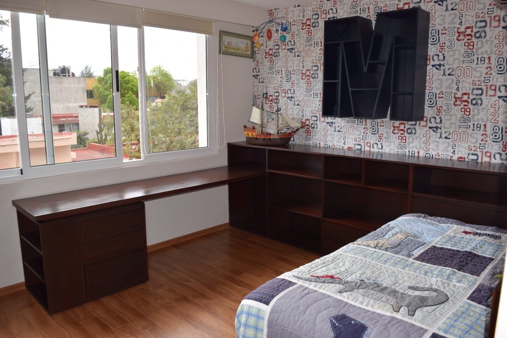 Medium sized contemporary children’s room for boys in Mexico City with light hardwood flooring.