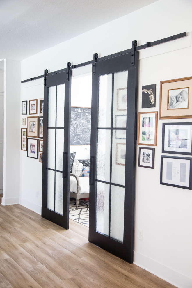 Small transitional gender-neutral ceramic tile and beige floor kids' room photo in Tampa with white walls