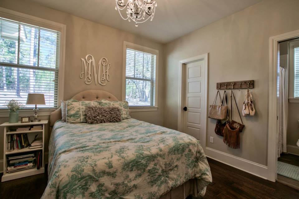 This is an example of a large romantic teen’s room for girls in Atlanta with beige walls and medium hardwood flooring.