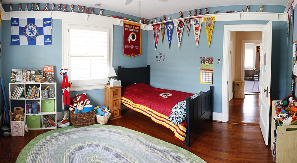 Design ideas for a medium sized children’s room for boys in DC Metro with medium hardwood flooring and blue walls.
