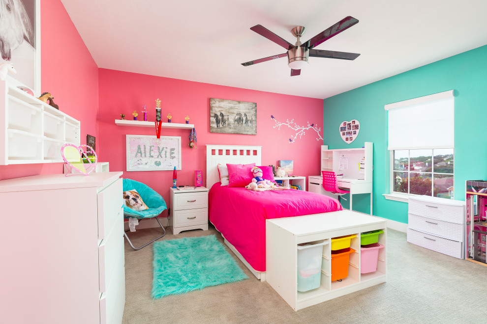 Photo of a medium sized contemporary children’s room for girls in Austin with pink walls and carpet.