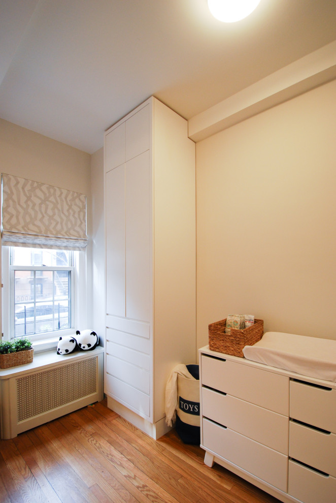Example of a mid-sized transitional girl medium tone wood floor kids' room design in New York with beige walls