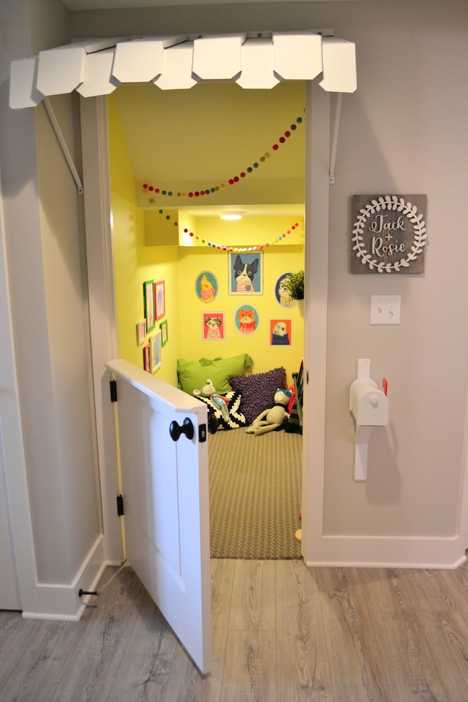 Photo of a small bohemian gender neutral playroom in Detroit with yellow walls, carpet and grey floors.