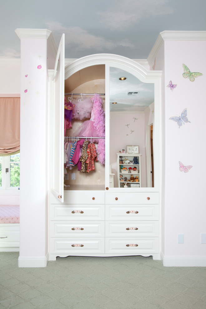 This is an example of a large traditional kids' bedroom for girls in Houston with pink walls and carpet.