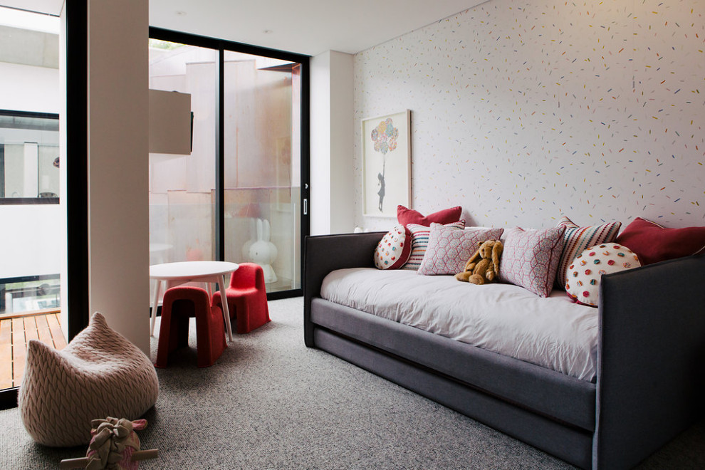 This is an example of an expansive contemporary kids' bedroom for girls in Sydney with carpet and grey floors.