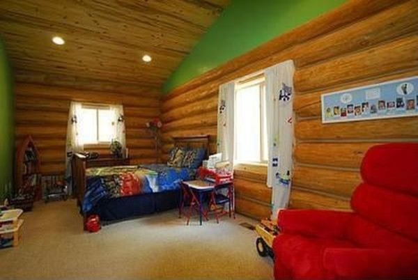 Example of a large mountain style boy carpeted kids' room design in Other with green walls