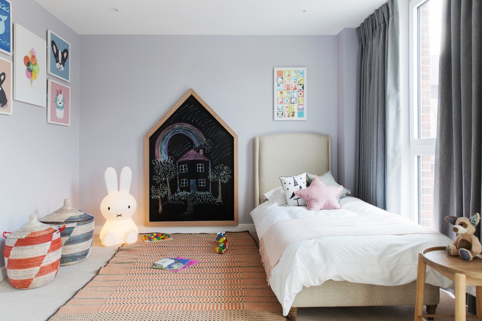 Traditional kids' bedroom in London with purple walls, carpet and beige floors.