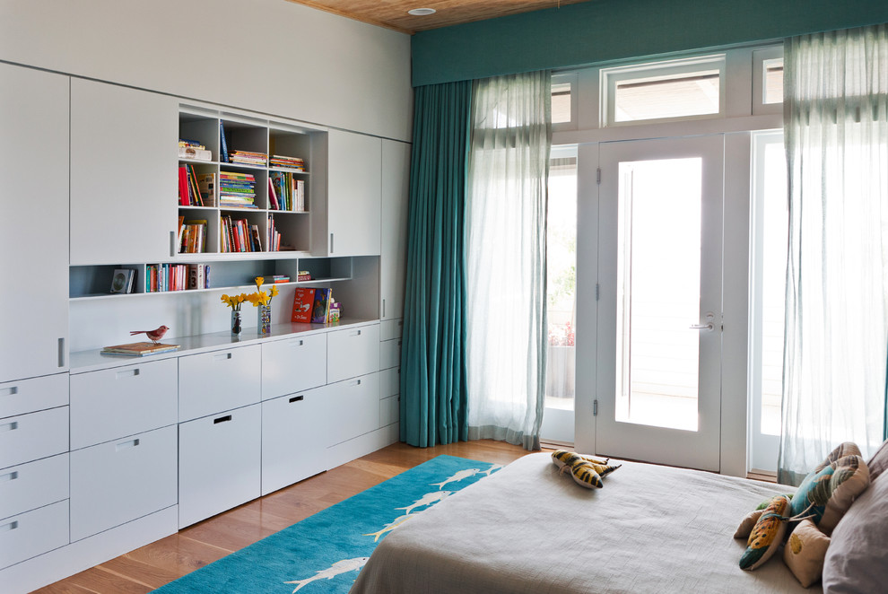 Design ideas for a contemporary teen’s room for girls in Los Angeles with white walls and medium hardwood flooring.