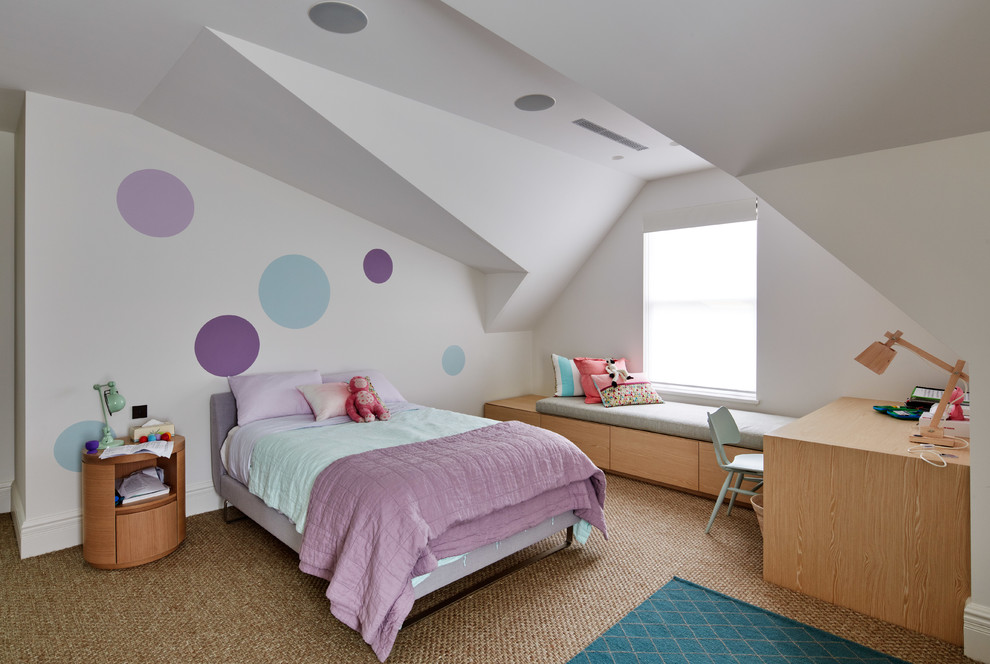 This is an example of a contemporary kids' bedroom for girls in Sydney with white walls and carpet.