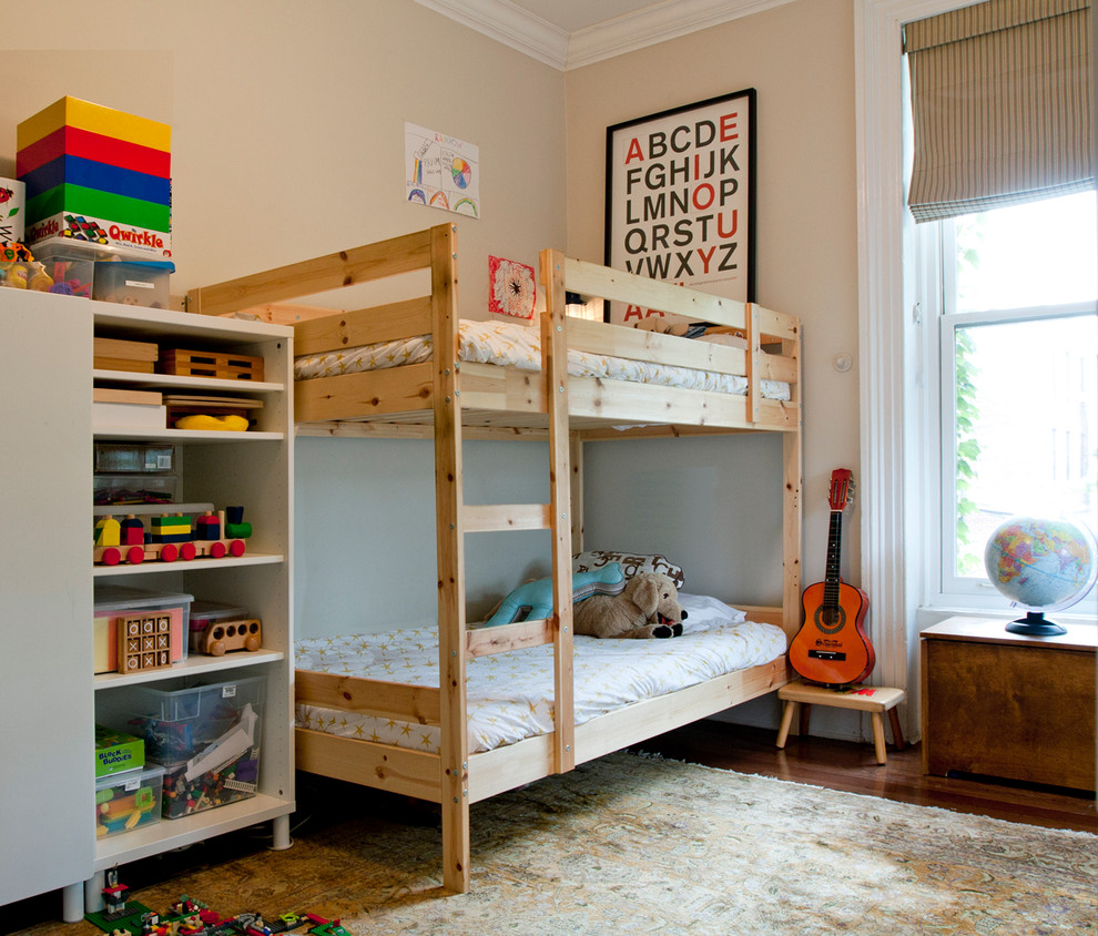 Photo of an eclectic gender neutral children’s room in New York with beige walls and dark hardwood flooring.
