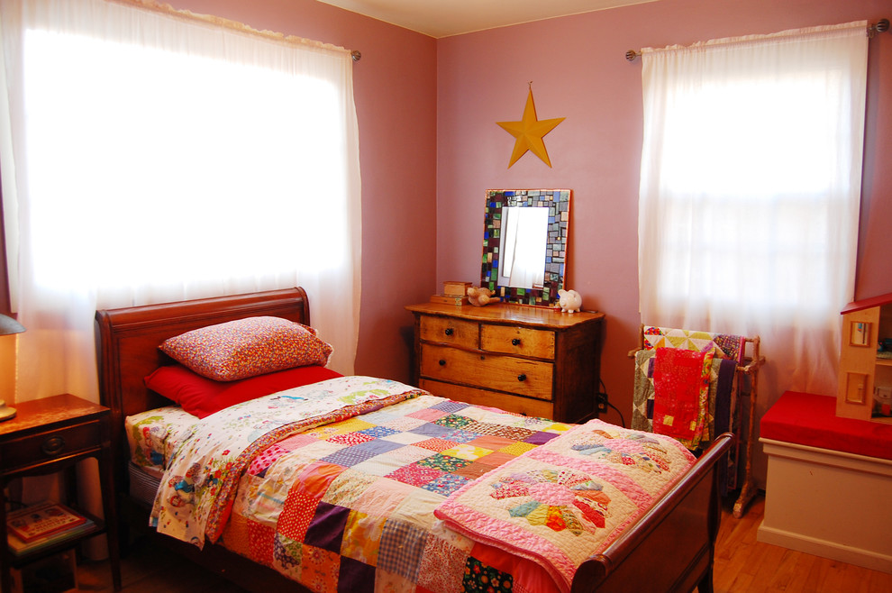 Eclectic kids' room photo in Portland with pink walls