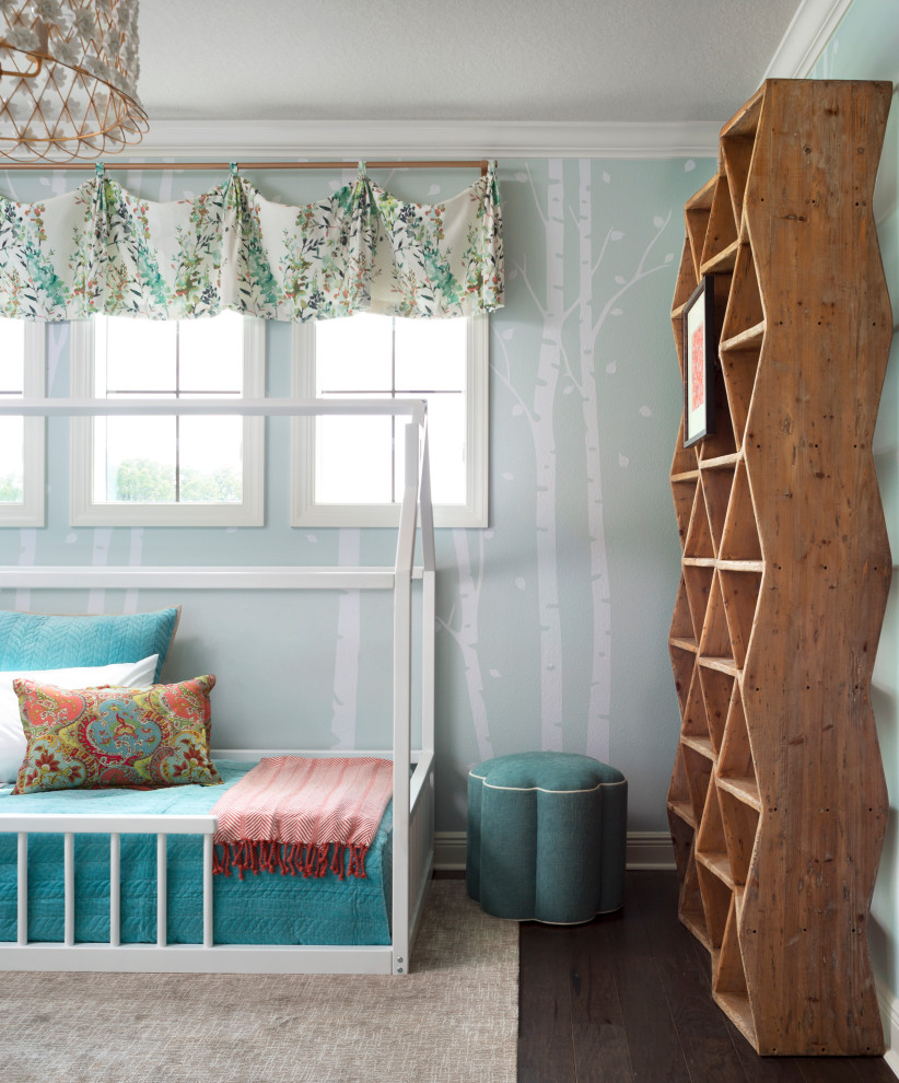 This is an example of a medium sized classic toddler’s room for girls in St Louis with green walls, medium hardwood flooring, brown floors and wallpapered walls.