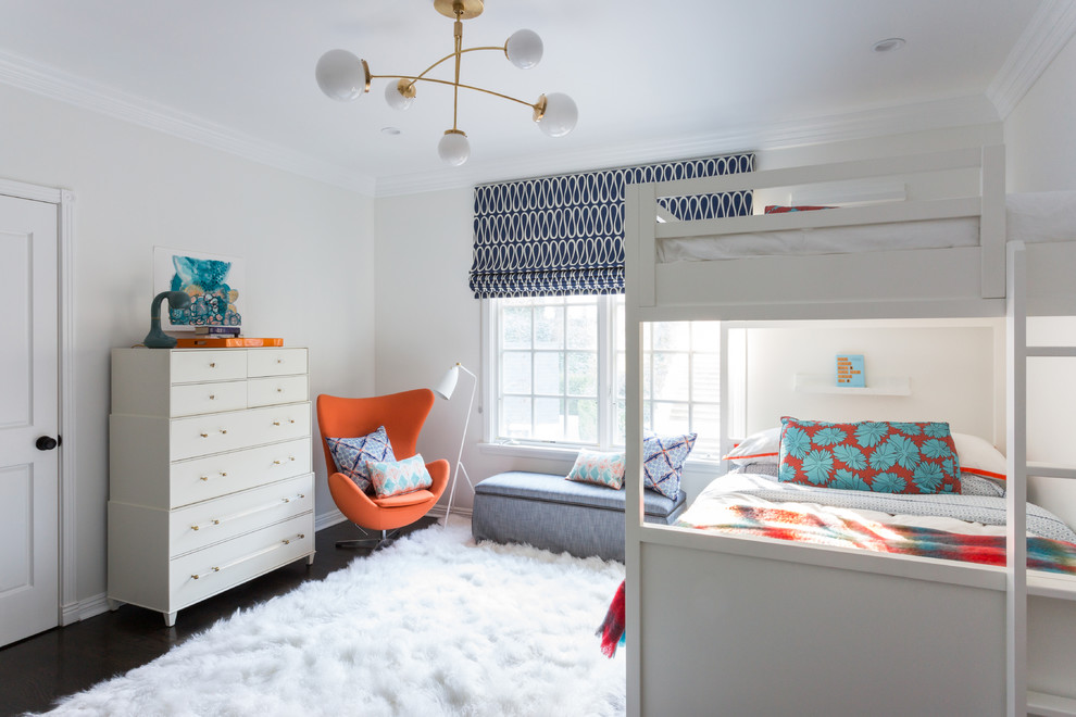 Medium sized traditional gender neutral children’s room in Los Angeles with white walls, dark hardwood flooring and brown floors.