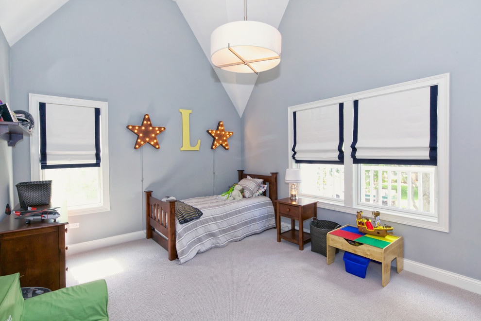Inspiration for a medium sized beach style children’s room for boys in Chicago with blue walls and carpet.