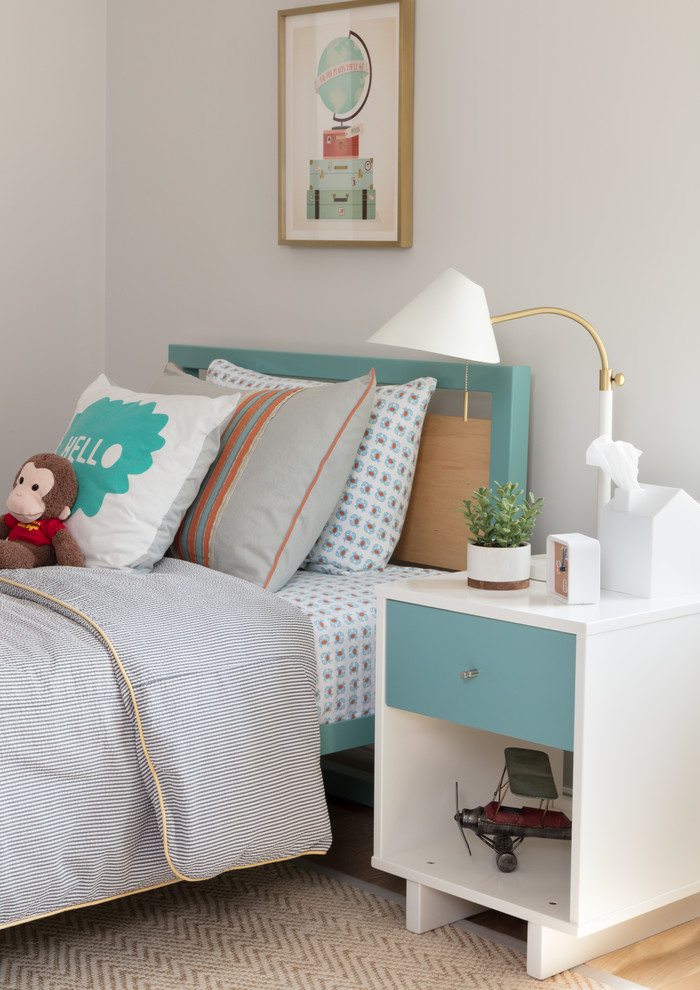 Mid-sized boy light wood floor kids' room photo in Boston with white walls
