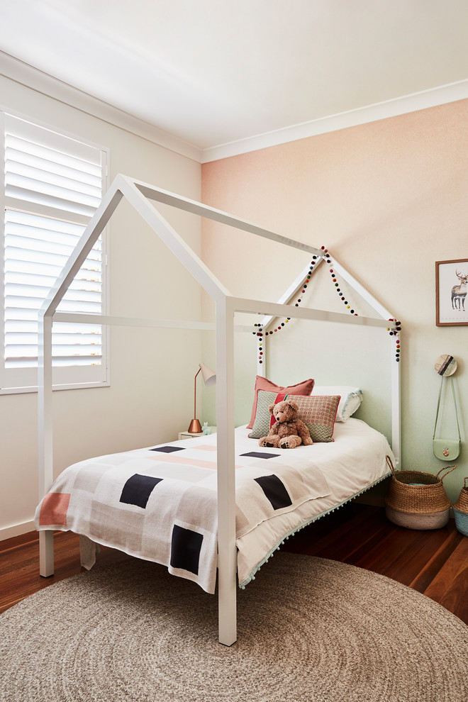 This is an example of a contemporary kids' bedroom in Sydney with green walls, medium hardwood flooring and brown floors.