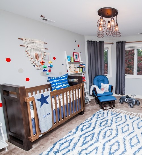 This is an example of a medium sized traditional toddler’s room for boys in Philadelphia with white walls and carpet.
