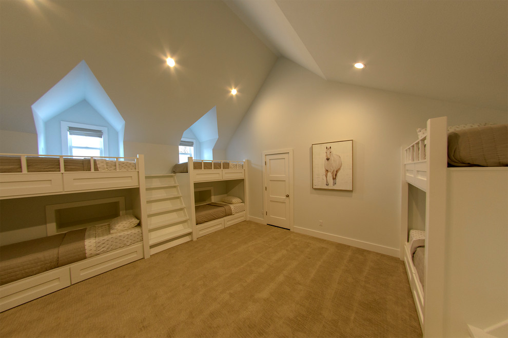 This is an example of a medium sized contemporary gender neutral kids' bedroom in Other with white walls, carpet and beige floors.