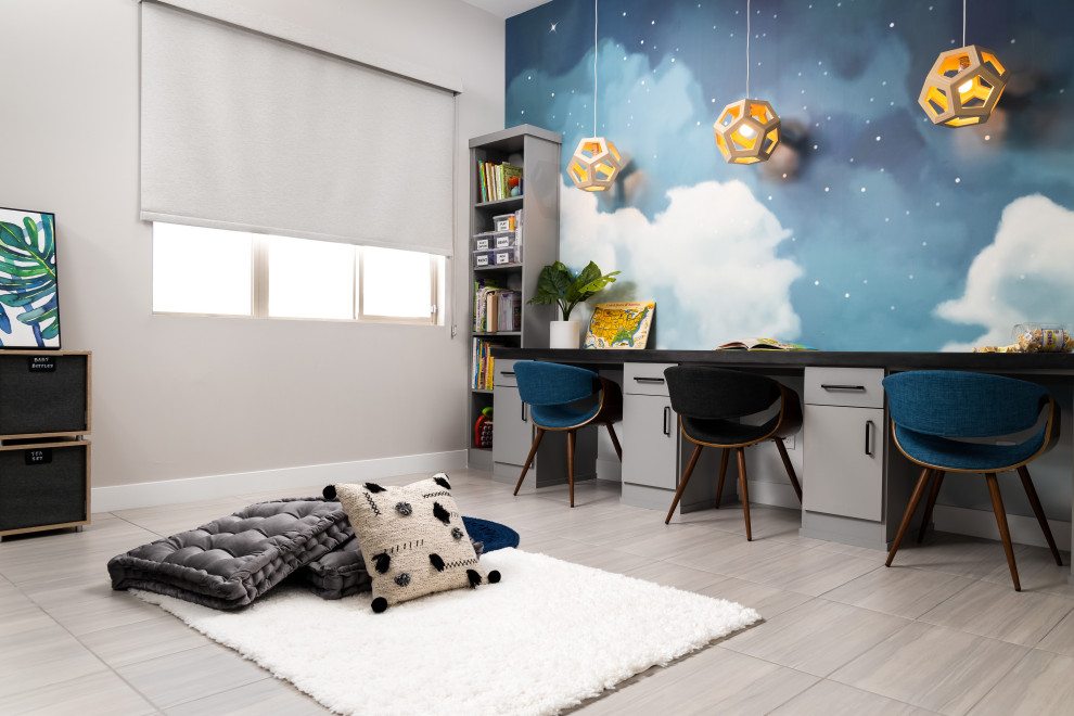 Idée de décoration pour une chambre d'enfant design avec un bureau, un mur gris et un sol gris.