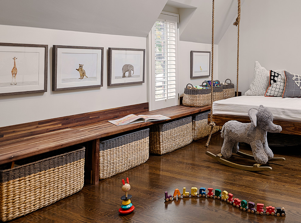 Esempio di una cameretta per bambini da 1 a 3 anni chic di medie dimensioni con pareti bianche e pavimento in legno massello medio