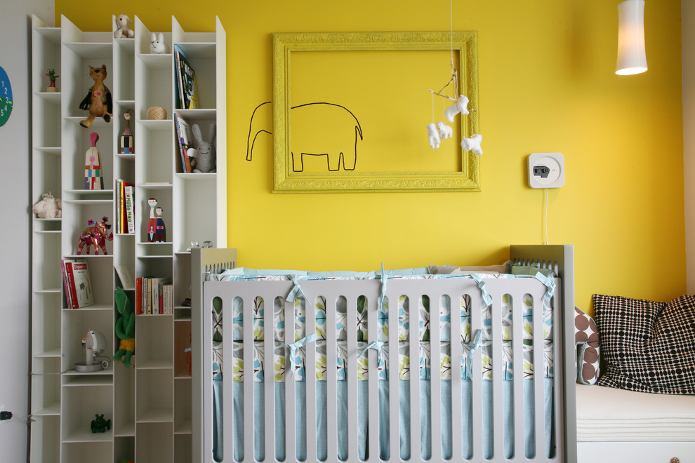 Contemporary gender neutral nursery in New York with yellow walls.