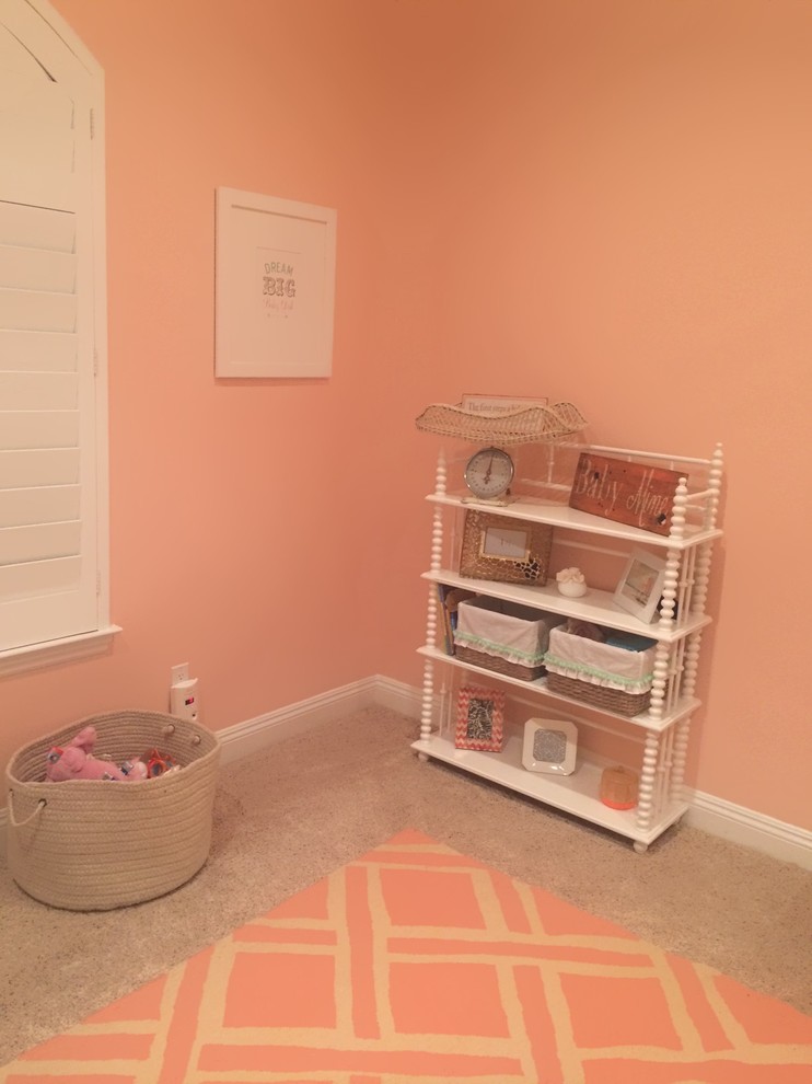 Design ideas for a medium sized romantic toddler’s room for girls in Orange County with pink walls and carpet.