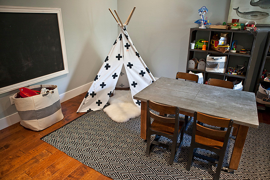 Medium sized urban kids' bedroom for boys in San Diego with grey walls and medium hardwood flooring.