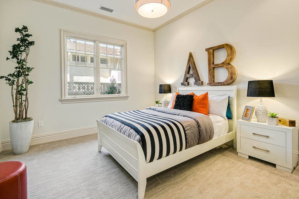 Traditional gender neutral teen’s room in Los Angeles with beige walls, carpet and beige floors.